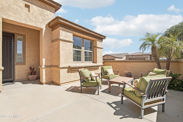 view of patio featuring an outdoor hangout area and fence