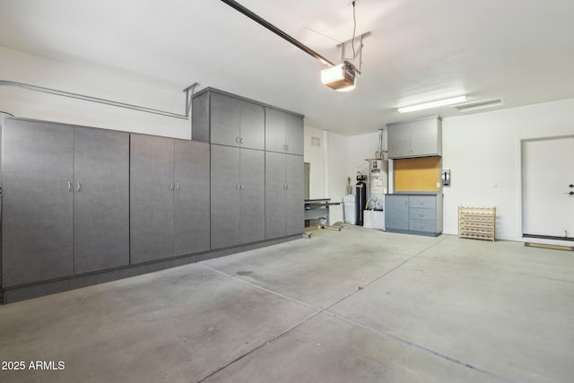 garage featuring water heater and a garage door opener