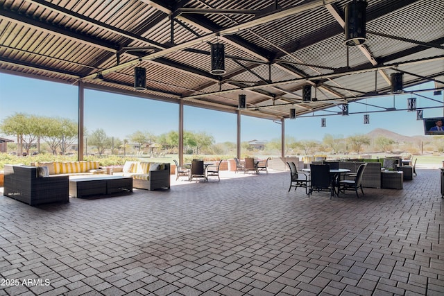 view of patio featuring an outdoor hangout area, a ceiling fan, and outdoor dining space