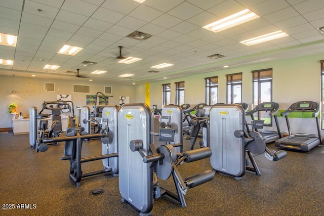workout area with a drop ceiling and visible vents