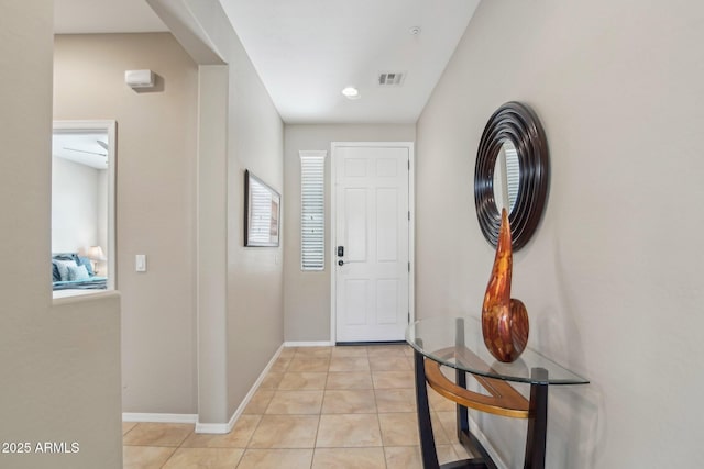 entryway featuring visible vents, baseboards, and light tile patterned flooring