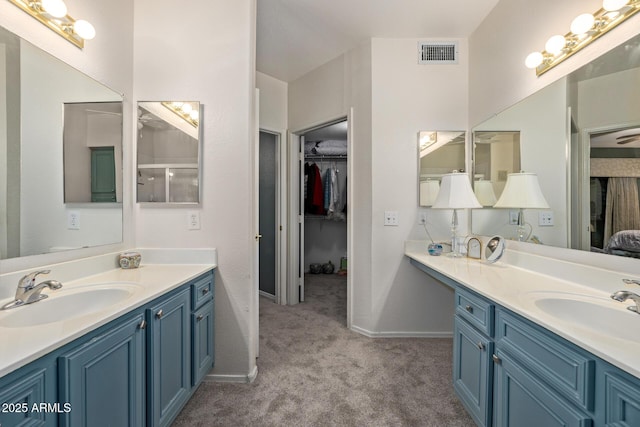 bathroom with vanity and a shower