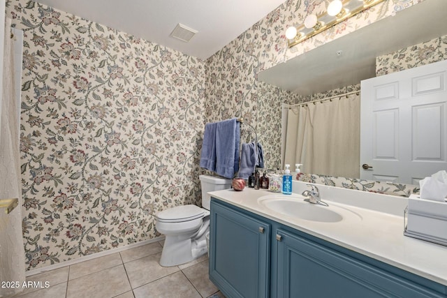 bathroom with vanity, tile patterned floors, and toilet