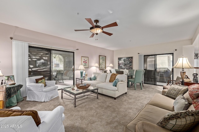 living room with ceiling fan, light colored carpet, and a healthy amount of sunlight