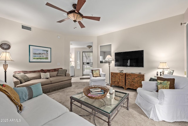 living room featuring light colored carpet and ceiling fan