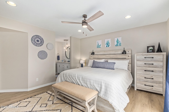 bedroom featuring sink, ceiling fan, and light wood-type flooring