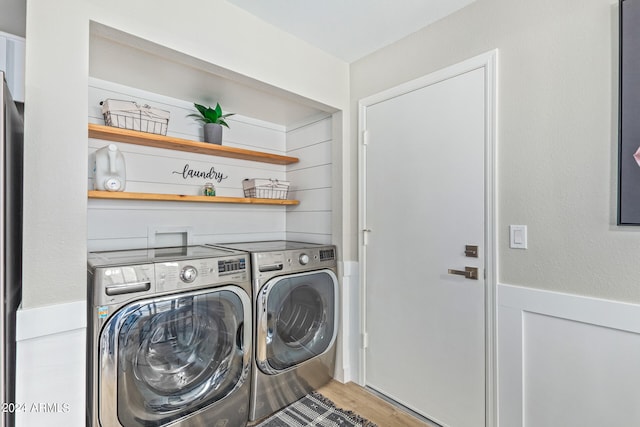 clothes washing area featuring hookup for a washing machine, separate washer and dryer, and light wood-type flooring