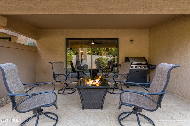 view of terrace featuring a grill and a fire pit