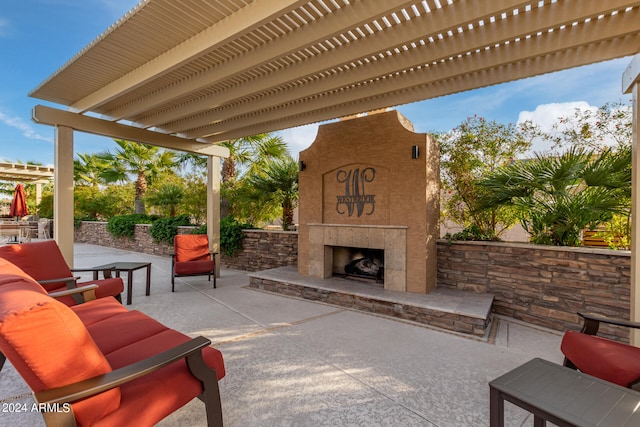 view of patio / terrace with exterior fireplace and a pergola