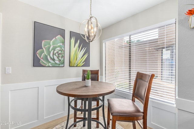 dining room with a notable chandelier, light wood-type flooring, and a wealth of natural light