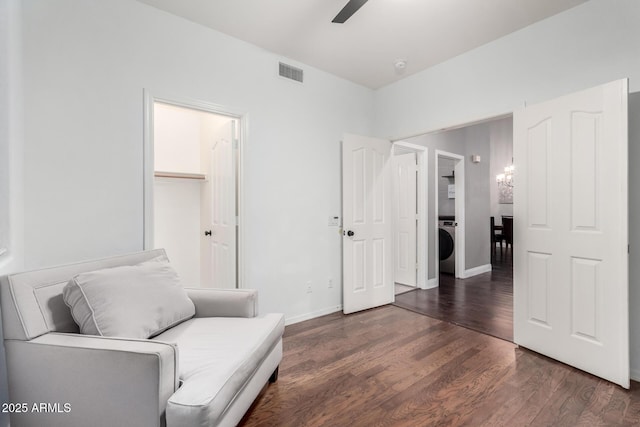 sitting room with ceiling fan, washer / dryer, and dark hardwood / wood-style flooring