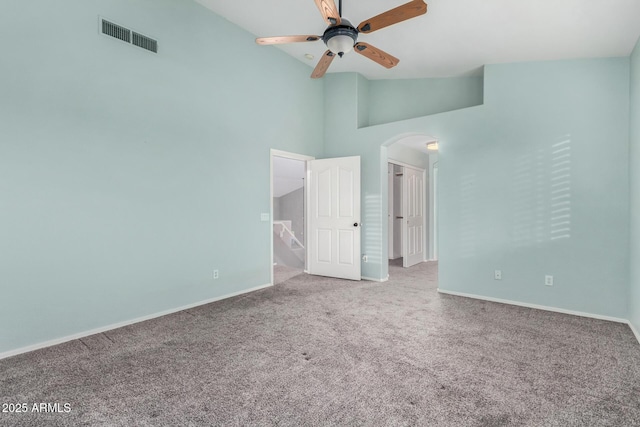 unfurnished bedroom featuring carpet floors, high vaulted ceiling, and ceiling fan