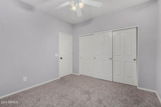 unfurnished bedroom featuring ceiling fan, carpet flooring, and a closet