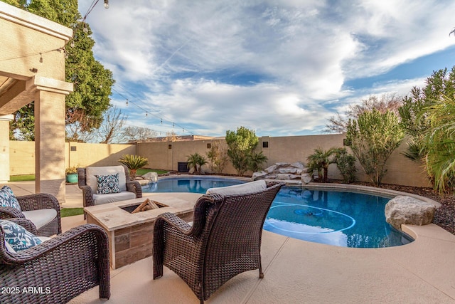 view of swimming pool with a fire pit