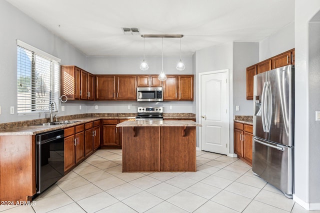 kitchen featuring sink, a center island, decorative light fixtures, light tile patterned floors, and appliances with stainless steel finishes