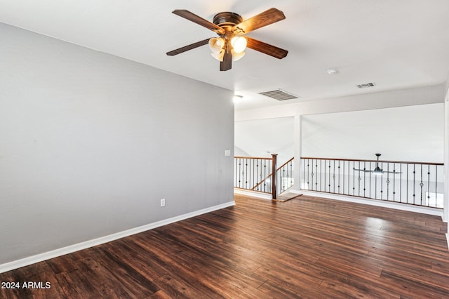 spare room with ceiling fan and dark hardwood / wood-style flooring