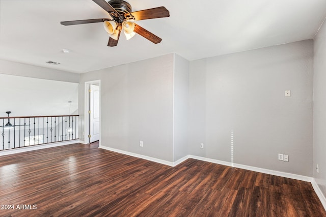 unfurnished room featuring ceiling fan and dark wood-type flooring