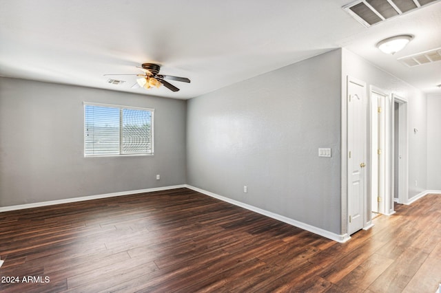 empty room featuring dark hardwood / wood-style floors and ceiling fan