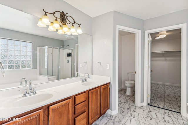 bathroom featuring vanity, an enclosed shower, and toilet