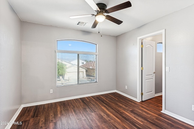 empty room featuring ceiling fan and dark wood-type flooring