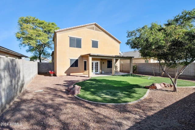 back of house with a patio and french doors