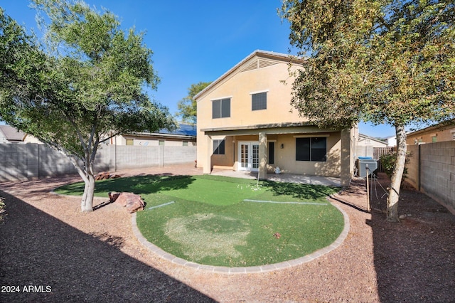 rear view of property with a patio area, central air condition unit, and french doors