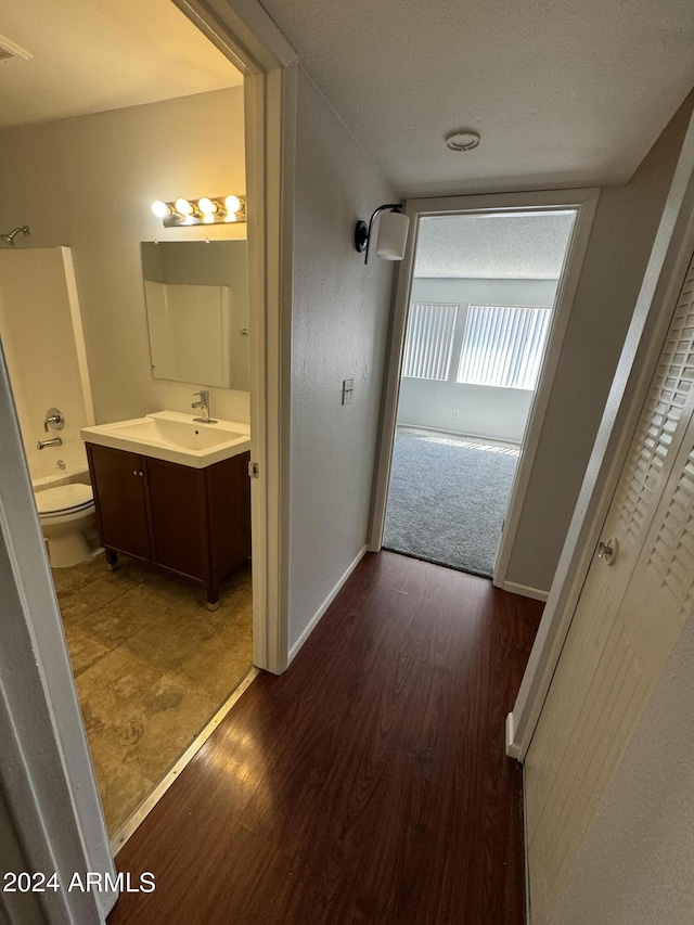 hallway featuring sink and dark hardwood / wood-style flooring