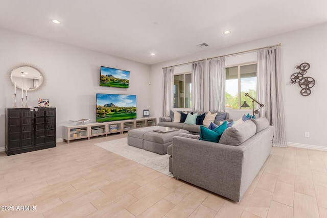 living room with recessed lighting, baseboards, visible vents, and light wood-type flooring
