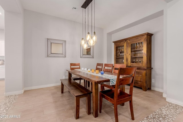 dining space with an inviting chandelier, baseboards, and visible vents