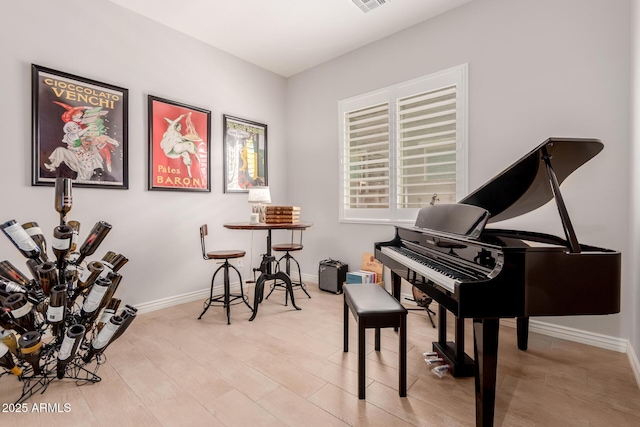 sitting room with baseboards and visible vents