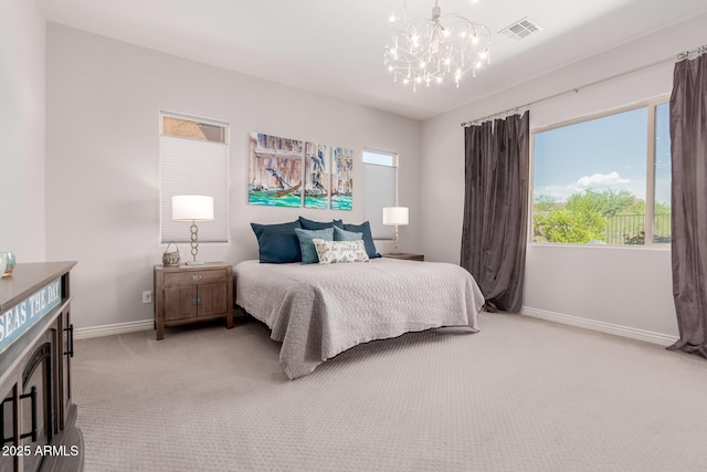 bedroom with baseboards, multiple windows, light carpet, and an inviting chandelier