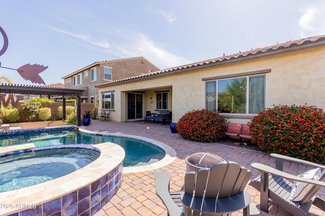 back of property with a patio, stucco siding, a pergola, and a pool with connected hot tub