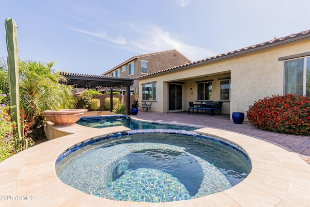 back of house featuring fence, a pergola, a pool with connected hot tub, stucco siding, and a patio area