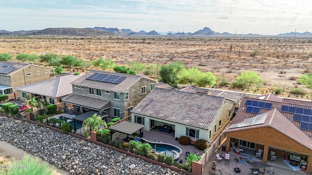 birds eye view of property featuring a desert view, a mountain view, a rural view, and a residential view