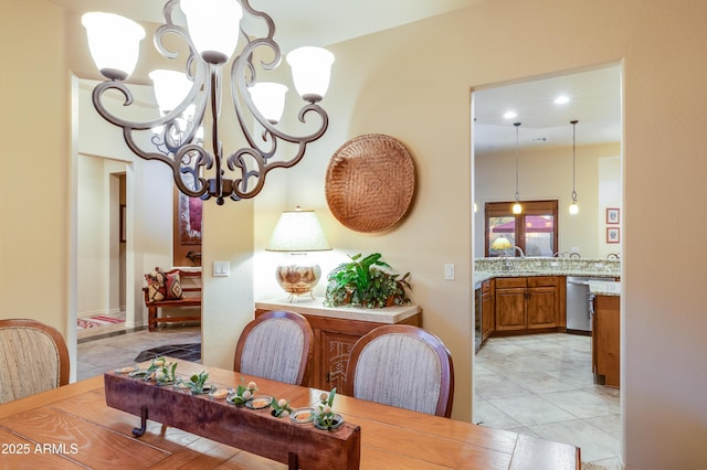 dining space with light tile patterned flooring and an inviting chandelier