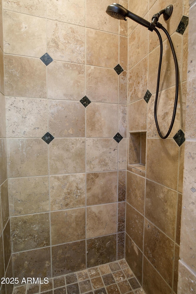 bathroom with tiled shower