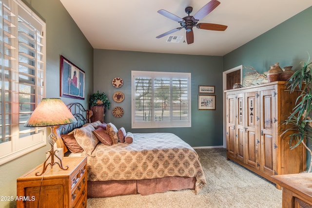 carpeted bedroom with ceiling fan, a closet, and multiple windows