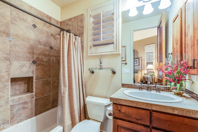 full bathroom featuring shower / bath combination with curtain, toilet, and vanity