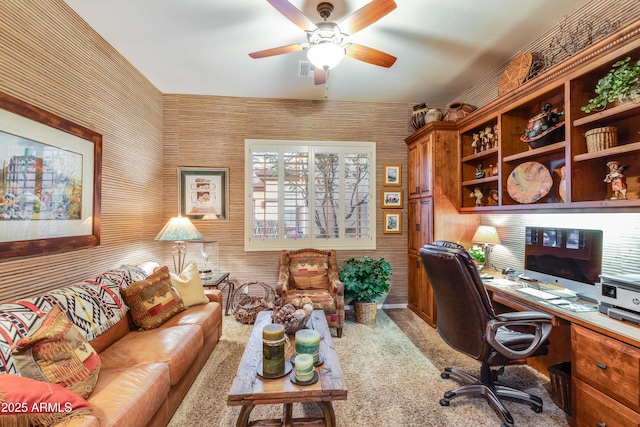 carpeted home office with ceiling fan