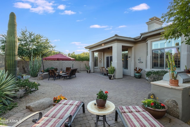 view of patio / terrace featuring an outdoor living space with a fire pit