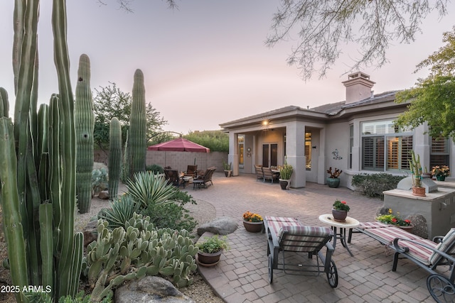 view of patio terrace at dusk