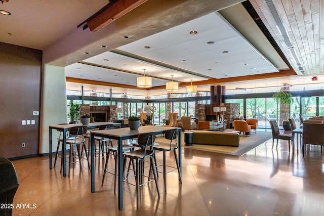 dining room with a tray ceiling and a wealth of natural light