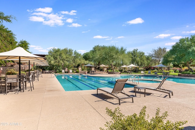 view of swimming pool with a community hot tub and a patio