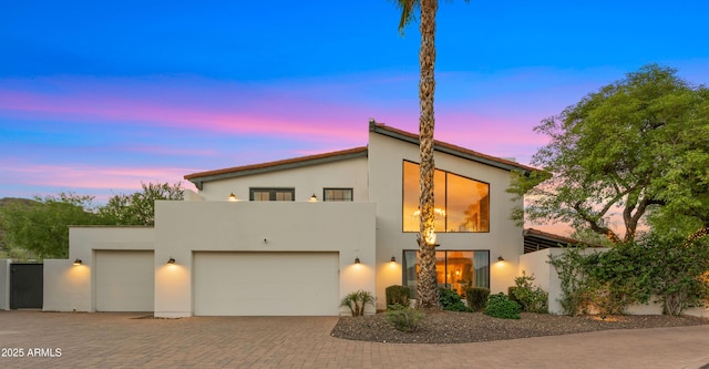 4824 E Hummingbird Ln, Paradise Valley, AZ 85253 - view of front facade featuring stucco siding, decorative driveway, and a garage