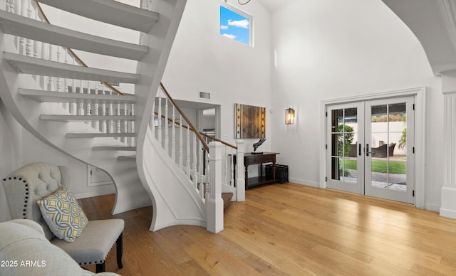 4824 E Hummingbird Ln, Paradise Valley, AZ 85253 - stairs with french doors, wood finished floors, and a high ceiling