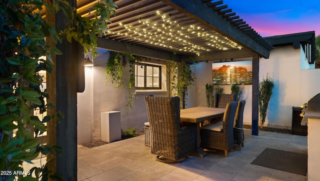 4824 E Hummingbird Ln, Paradise Valley, AZ 85253 - patio terrace at dusk featuring a pergola, outdoor dining space, and a patio area