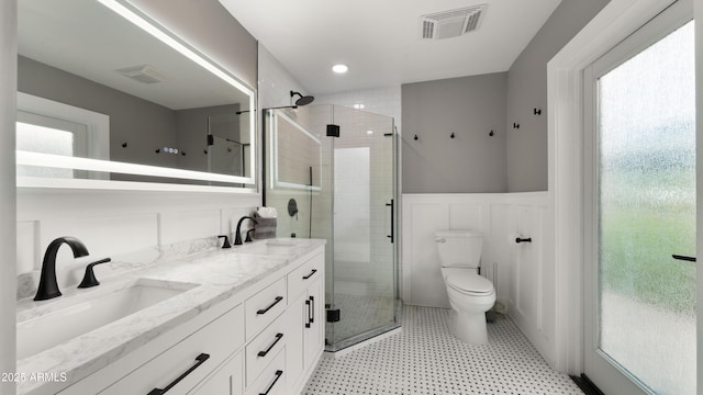 4824 E Hummingbird Ln, Paradise Valley, AZ 85253 - bathroom featuring a wainscoted wall, a shower stall, double vanity, and a decorative wall