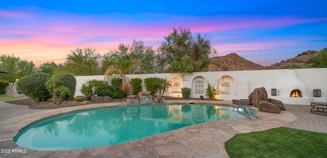 4824 E Hummingbird Ln, Paradise Valley, AZ 85253 - pool at dusk featuring a patio area