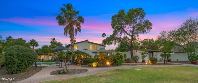 4824 E Hummingbird Ln, Paradise Valley, AZ 85253 - view of front of home with a yard, curved driveway, and an outdoor pool