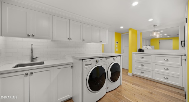 4824 E Hummingbird Ln, Paradise Valley, AZ 85253 - laundry area with washing machine and clothes dryer, light wood-type flooring, recessed lighting, and cabinet space